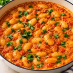 Creamy butter chicken beans with tender butter beans in a rich tomato cream sauce topped with cilantro