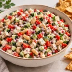 Scoopable salad with chicken, cannellini beans, cucumber, tomatoes, red bell pepper, red onion, herbs, and tortilla chips