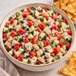 Scoopable salad with chicken, cannellini beans, cucumber, tomatoes, red bell pepper, red onion, herbs, and creamy lemon dressing