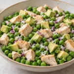 Viral chicken and peas recipe with cooked chicken, avocado, Parmesan, and red onion