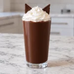 Homemade chocolate Black Cat Frappuccino topped with whipped cream and two chocolate cat ears